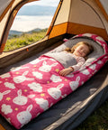 Child sleeping in Bright Pink 3 Season Kid Friendly Sleeping Bag For Camping And Backpacking Lightweight And Waterproof With Carry Bag Perfect For Hiking Outdoor Travel Boys And Girls Cozy All Weather Sleep Gear inside a tent.
