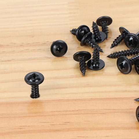 Close-up of 120 Piece Size Eight Phillips Truss Head Black Wood Screw Kit for Wall Plates and Woodworking Self Tapping Fasteners on wood surface.