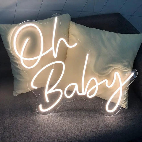 Dimmable LED Neon Sign With Transparent Acrylic Backplate, Indoor Wall Decor In Warm White, Oh Baby design on couch