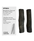 Two charcoal water purifying sticks from Kishu Japan, each filtering up to 2 liters, beside packaging showing product details.