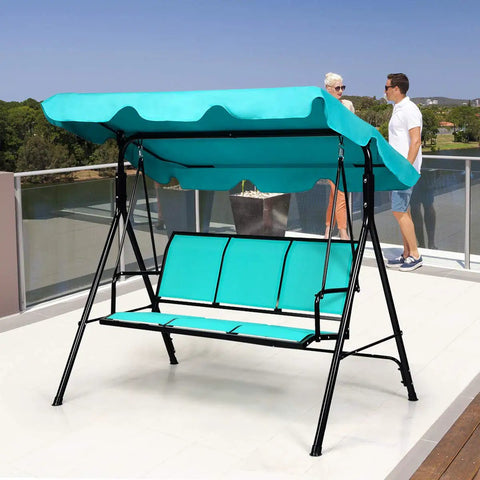 Three Seat Patio Swing With Steel Frame And Adjustable Canopy, All Weather Resistant Rocking Bench For Cozy Patio, Garden, Poolside Or Balcony, Turquoise Finish on a terrace.