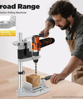Man using portable drill press stand and hand drill adapter aluminum base single hole workstation for precise drilling.