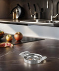 Pomegranate Must Have Deseeder And Pulp Separator Set in 304 stainless steel on kitchen counter with fruits in background