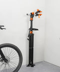Heavy Duty Bike Repair Stand With Four Leg Base Adjustable 42.5 To 74.8 Inch Height Foldable Maintenance Stand in garage setup.