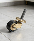 Solid Brass Caster Wheels 4pcs Silent Bearing Furniture, close-up of one wheel with black rubber tire and brass swivel mount.