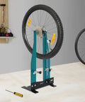 Professional Bicycle Wheel Truing Stand Removable Multifunction Wheel Alignment Tool Fits 16 To 29 Inch Mountain Bikes And 700c Road Bikes For Rim Calibration And Maintenance, positioned in a workshop.
