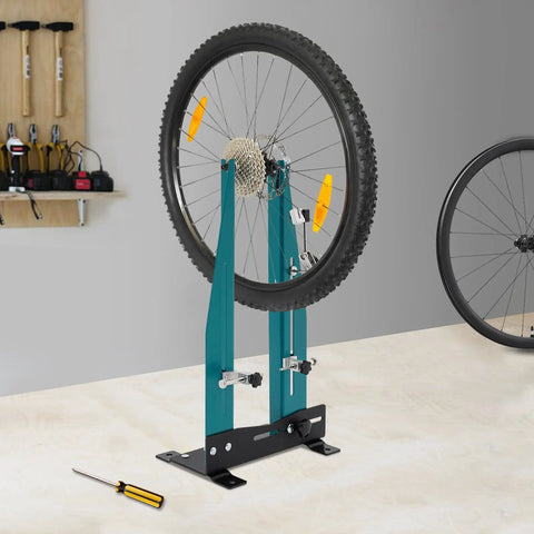 Professional Bicycle Wheel Truing Stand Removable Multifunction Wheel Alignment Tool Fits 16 To 29 Inch Mountain Bikes And 700c Road Bikes For Rim Calibration And Maintenance, positioned in a workshop.