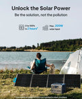 Portable Power Station With 268Wh LiFePO4 Battery Solar Generator placed next to solar panels by a lake, camping setup visible.