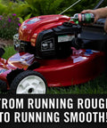 Kickstart Your Rig Small Engine Fuel Treatment And Carb Cleaner poured into a red lawn mower for smooth operation.