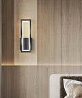 Sleek Rectangular LED Wall Sconce Delivering Flat Out Stunning Three Tone Lighting And Smooth Acrylic Glow mounted above a bed.