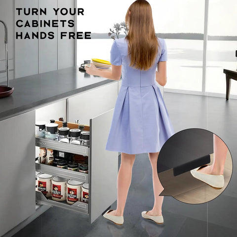 Woman using Under Cabinet Foot Pull Opener 4.5 Inch Matte Black Hands Free Toe Kick for kitchen trash cabinet, demonstrates foot action