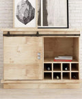 Wooden cabinet with sliding barn door, featuring metal rails and wine storage on white brick wall backdrop.