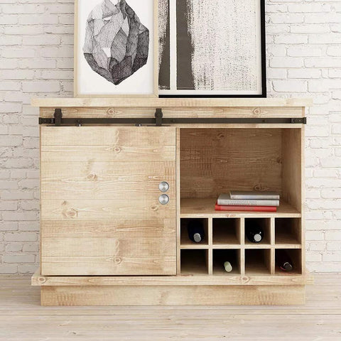 Wooden cabinet with sliding barn door, featuring metal rails and wine storage on white brick wall backdrop.
