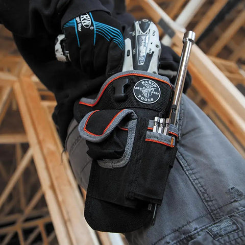 Tradesman Pro Drill Pouch With Pockets For Tools And Bits, Heavy Duty 1680D Ballistic Weave on a worker's belt holding drill and tools