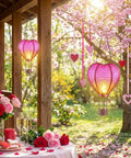 Heart Shaped Solar Lantern For Outdoor Decor Bright Hanging Light With Flickering Flame Garden Party Accent alongside flowers.