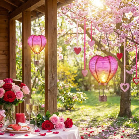 Heart Shaped Solar Lantern For Outdoor Decor Bright Hanging Light With Flickering Flame Garden Party Accent alongside flowers.