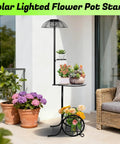 Solar lighted flower pot stand with colorful potted plants next to wicker sofa on a sunny patio.