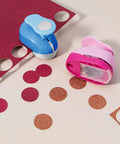 Pink and blue circle punches from the Six Size Circle Punch Set For Paper Crafts With Easy Operation And Color Vibes on glitter paper