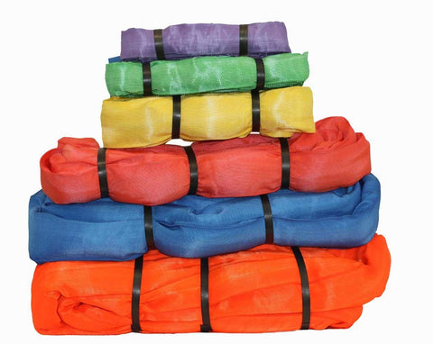 Stack of multicolored nylon round slings in various sizes for industrial lifting and crane applications.