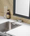 Premium RV Sink Faucet with Spotless Chrome Finish Heavy Duty 360 Swivel Marine Cold Water Tap Compact Deck Mount Setup for Camper Van Yacht and Weekend Road Trips, installed over stainless sink.