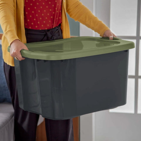 Roomy 17.5 Gallon Plastic Storage Bin With Secure Stackable Lid And Opaque Base held by a person, showcasing full grip handles.