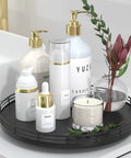 Rock Solid 12 Inch Black Oak Lazy Susan Turntable Tray with beauty products and candle on a bathroom counter.