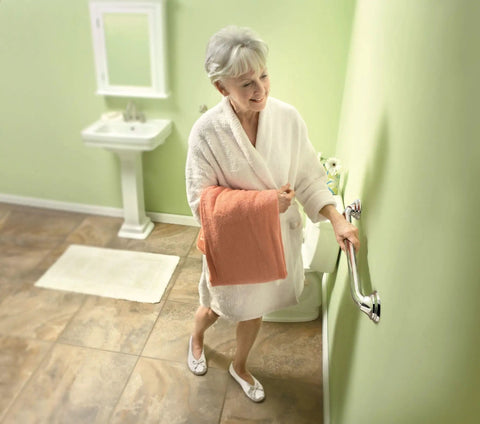 Elderly woman using Chrome 24 Inch Designer Shower Grab Bar With Curled Grip, Heavy Duty Bathroom Safety Rail Up To 500 Lbs