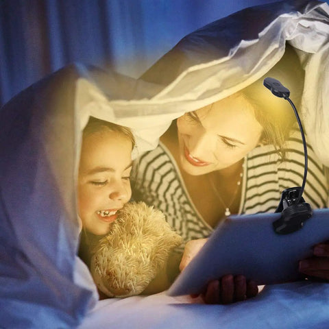 Mother and child using Rechargeable Clip On LED Book Light With Warm Natural Cool White Colors And Nine Brightness Levels under blanket