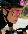 Cyclist wearing Polarized Sports Sunglasses With UV 400 Protection For Women And Men, Ultra Lightweight Frameless Running Glasses In Pink