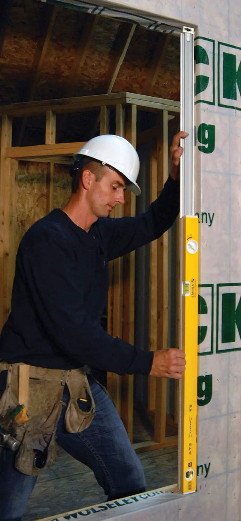 Worker using Extendable 36 Inch Level With Locking Design And Continuous Marking Edge Type 80T for precise on site measurements.