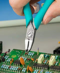5 Inch Angled Tip Cutter With Ergonomic Co Molded Grip For SMT Lead Trimming, Durable Eremadium Tool Steel, EMOS Stop, Precision Electronics Pliers For Circuit Boards And Fine Wire Work being used on a circuit board.