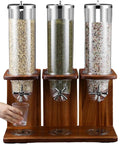 Triple Head Cereal And Grain Dispenser For Kitchen Counter Holds Four Liters Each Solid Wood Base With Steel Lid Heavy Duty Pc Buckets Keep Snacks Fresh Smooth Pouring Design, showcasing three bins with a hand pouring.