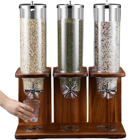 Triple Head Cereal Dispenser With Spacious Clear Storage Barrel And Rustic Wood Base, filled with oats, beans, and dried snacks.