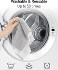 Fantasticlean gray microfiber cleaning towel held by hand in front of washing machine drum