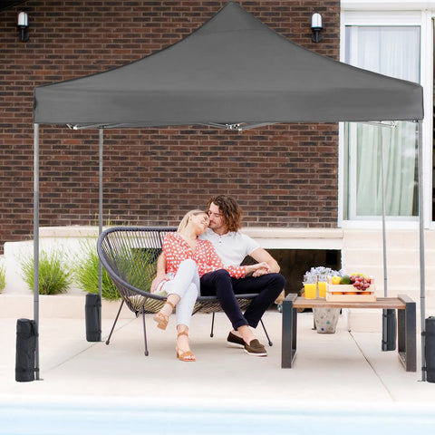 Couple under 10x10 Ft Pop Up Canopy Tent with Sand Bags Easy Up Instant Shelter for camping, parties, beach, patio events.