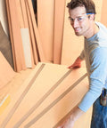 Worker handling 200 Piece Heavy Duty Cardboard Drywall Shims For Straightening Wavy Studs And Lifting Baseboards No Sweat Butt Joint Tuck Rock Solid Kraft Board.