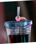 Pink charm from Six Colorful Straw Charm Covers Set For Cups And Parties snapped on a wide straw in a tumbler