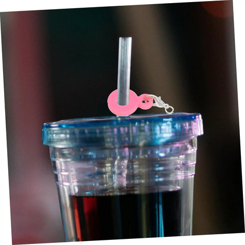 Pink charm from Six Colorful Straw Charm Covers Set For Cups And Parties snapped on a wide straw in a tumbler
