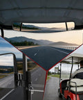 Universal Golf Cart Mirrors Offering HD Wide Angle Shatterproof Glass view from rear and side mirrors in a golf cart, showing roads.