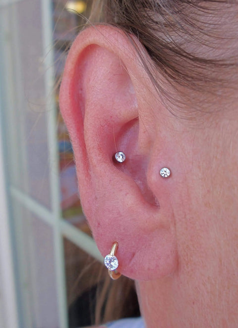 Threadless Piercing Tapers Set Go To For Changing And Insertion Tools 16G 18G 20G Titanium Threadless Insertion Pins in use on ear