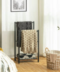 Freestanding Towel Rack And Blanket Holder For Bathroom, Two Tier Drying And Display Shelf In Rustic Brown And Black Finish, Measures 16.5 Inches Long By 9.4 Inches Wide By 31.5 Inches High, Ideal For Towels Blankets Laundry And Everyday Clutter Control with blankets in a bright room