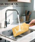Bamboo cutting board with handle under running water in kitchen sink, 11 by 5 inches