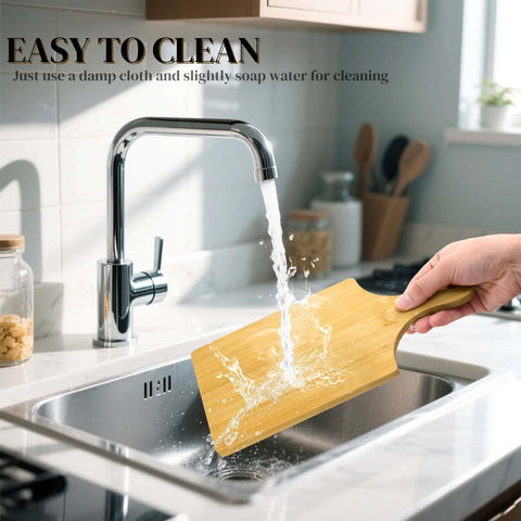 Bamboo cutting board with handle under running water in kitchen sink, 11 by 5 inches