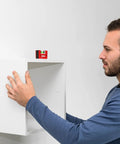 Man using Sola Spirit Level Compact Go! Clip, 0 to align a white shelf, demonstrating its compact and handy features.
