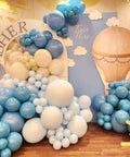 Up Up And Away Balloon Garland Arch Kit With 152 Pieces Dusty Slate Fog Blue Sand White Balloons Plus Hot Air Balloon And Cloud Foil Balloons For Baby Shower Teddy Themed Party Decor That Looks Totally Insta Worthy And Kid Approved displayed as arch in party setup.