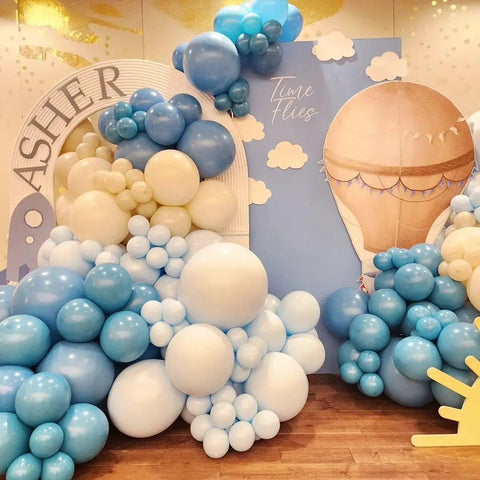 Up Up And Away Balloon Garland Arch Kit With 152 Pieces Dusty Slate Fog Blue Sand White Balloons Plus Hot Air Balloon And Cloud Foil Balloons For Baby Shower Teddy Themed Party Decor That Looks Totally Insta Worthy And Kid Approved displayed as arch in party setup.