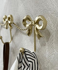 Kickass Heavy Duty Wall Mounted Coat Hook Bulletproof Metal Clothes Hanger with decorative bows, ideal for stylish organization.