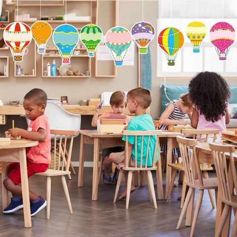 Classroom with kids and colorful hot air balloon cutouts from the Colorful Hot Air Balloon Cutouts Set for Classroom Decor 36 Pieces in 9 Designs.