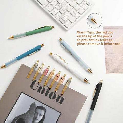 Gold 12 Pack Retractable Ballpoint Pens With Ultra Soft Grip 1.0mm Point Smooth Black Ink arranged with keyboard and notepad