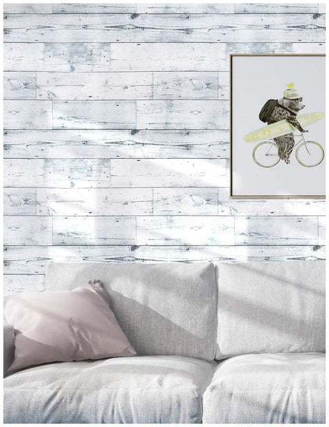 Living room with Peel And Stick Wood Shiplap Wallpaper In Light Grey White And Blue Distressed Planks above a light gray sofa.